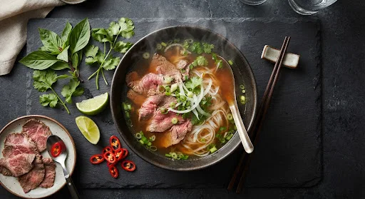 Vietnamská polévka Phở s bylinkami, limetkou a chilli